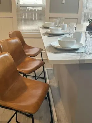 a table with chairs and bowls and plates on it at Little house on 47th in Cleveland