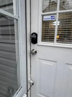 a door with a sign on it next to a window at Little house on 47th in Cleveland