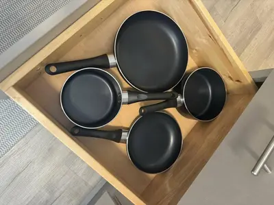 a set of four pots on a wooden table at Little house on 47th in Cleveland