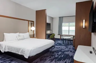 a hotel room with a bed and a desk at Fairfield by Marriott Port Clinton Waterfront in Port Clinton
