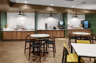 a restaurant with tables and chairs and a counter at Fairfield by Marriott Port Clinton Waterfront in Port Clinton