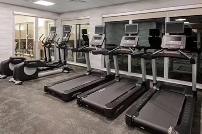 a gym with several treadmills and elliptical machines at Fairfield by Marriott Port Clinton Waterfront in Port Clinton