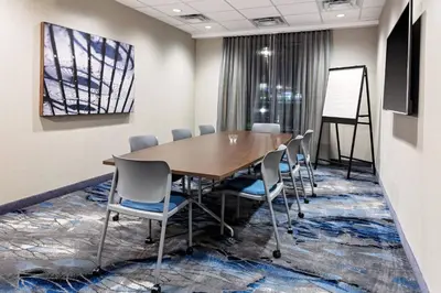a conference room with a wooden table and chairs at Fairfield by Marriott Port Clinton Waterfront in Port Clinton