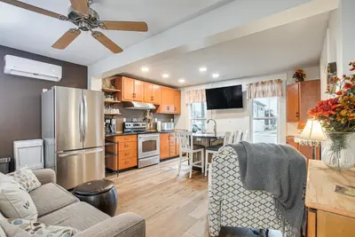 a living room with a couch and a kitchen at West Liberty Vacation Rental Near Mad River! in West Liberty