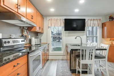 a kitchen with wooden cabinets and a counter top at West Liberty Vacation Rental Near Mad River! in West Liberty