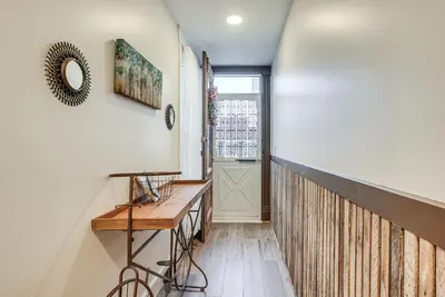 a hallway with a wooden table and a window at West Liberty Vacation Rental Near Mad River! in West Liberty