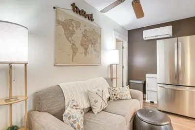 a living room with a couch and a refrigerator at West Liberty Vacation Rental Near Mad River! in West Liberty