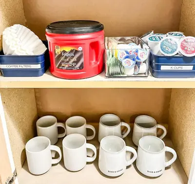 a shelf with cups and other items in a box at Anchors Away - Relaxing Cottage Minutes from Lake in Buckeye Lake