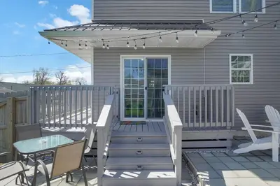 a deck with a table and chairs and a table and chairs at Anchors Away - Relaxing Cottage Minutes from Lake in Buckeye Lake