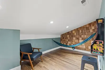 a room with a chair and a hammock on the wall at New Barndo/Private River Access/ 2 Private Hot Tub in Stanton
