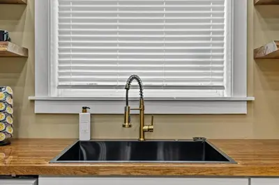 a sink in a kitchen with a window at New Barndo/Private River Access/ 2 Private Hot Tub in Stanton