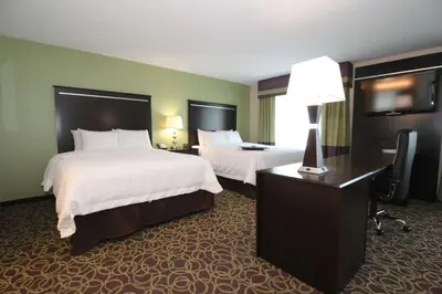 a hotel room with two beds and a desk with a lamp at Hampton Inn and Suites Sandusky/Milan in Milan