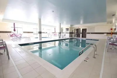 a large swimming pool with blue water in a building at Hampton Inn and Suites Sandusky/Milan in Milan