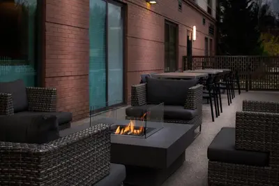 a patio with couches and a fire pit and tables at Fairfield Inn & Suites by Marriott Charleston in Charleston