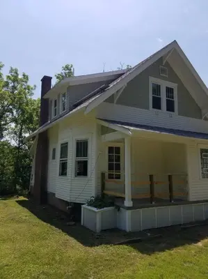 a yellow house with a porch and a yard at 5 minutes by car to OU, 2 Bedroom, 1.5 bath, Wi-Fi in Athens