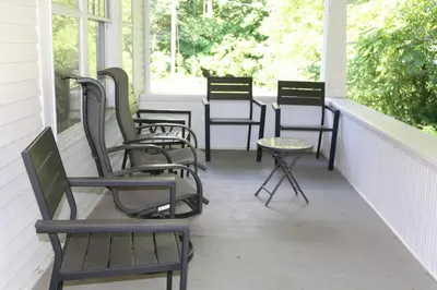 four chairs and a table on a porch at 5 minutes by car to OU, 2 Bedroom, 1.5 bath, Wi-Fi in Athens