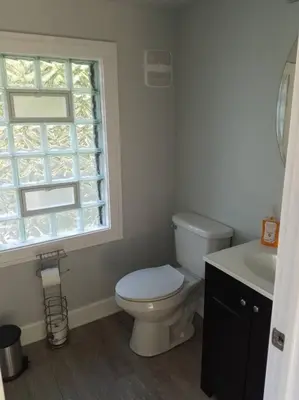 a bathroom with a toilet and a sink and a window at 5 minutes by car to OU, 2 Bedroom, 1.5 bath, Wi-Fi in Athens