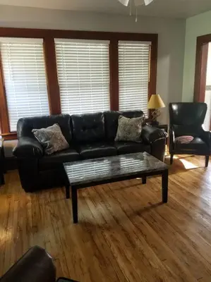 a living room with a black leather couch and a coffee table at 5 minutes by car to OU, 2 Bedroom, 1.5 bath, Wi-Fi in Athens