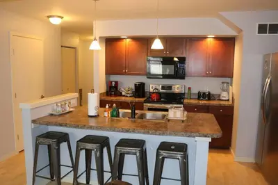 a kitchen with a counter with bar stools at Athens city townhouse, 3 bedroom, 2.5 baths, Wi-Fi in Athens