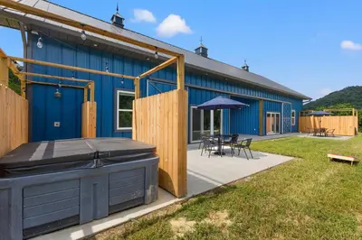 a blue building with a grill in the yard at New Barndo/Kayak Launch/ 2 Private Hot Tubs in Stanton