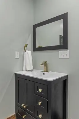 a bathroom with a black sink and a mirror at New Barndo/Kayak Launch/ 2 Private Hot Tubs in Stanton
