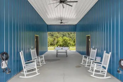 a room with chairs and a table and a ceiling fan at New Barndo/Kayak Launch/ 2 Private Hot Tubs in Stanton
