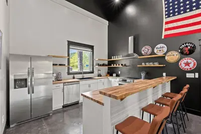 a kitchen with an american flag on the wall at New Barndo/Kayak Launch/ 2 Private Hot Tubs in Stanton