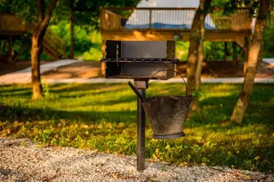 a bird feeder with a bucket in a park at Red River Elusive Elk Glamping Tent 1 in Stanton
