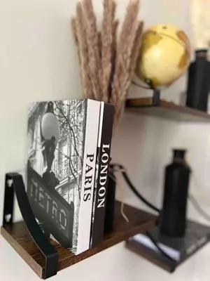 a book sitting on a shelf next to a lamp at Quiet 2-Bedroom Condo with Garage and Fast Wi-Fi in Fort Wayne