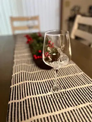 a wine glass sitting on top of a table at Quiet 2-Bedroom Condo with Garage and Fast Wi-Fi in Fort Wayne