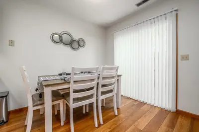 a dining room with a table and chairs and a window at Quiet 2-Bedroom Condo with Garage and Fast Wi-Fi in Fort Wayne