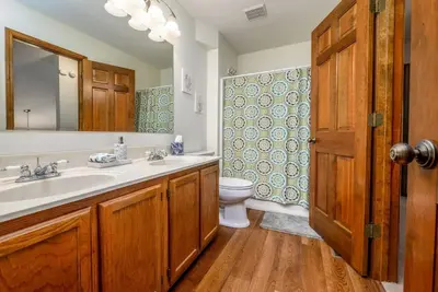 a bathroom with a sink and a toilet and a mirror at Quiet 2-Bedroom Condo with Garage and Fast Wi-Fi in Fort Wayne