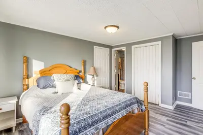 a bedroom with a bed with a blue comforter at Pet-Friendly Union Home about 19 Mi to Cincinnati! in Union