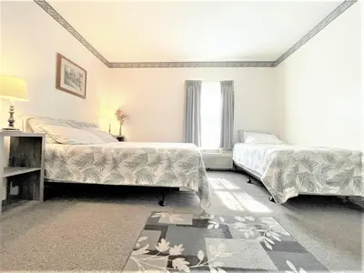a bedroom with two beds and a window at Bittersweet Inn in Paulding