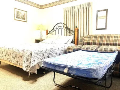 a bedroom with a bed and a couch at Bittersweet Inn in Paulding