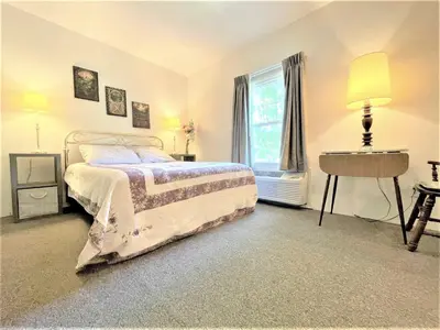 a bedroom with a bed and a window at Bittersweet Inn in Paulding
