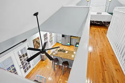 a room with a dining table and a ceiling fan at Lakefront, Private Covered Dock, Huge Balconies in Williamstown