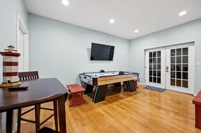 a living room with a pool table and a flat screen tv at Lakefront, Private Covered Dock, Huge Balconies in Williamstown