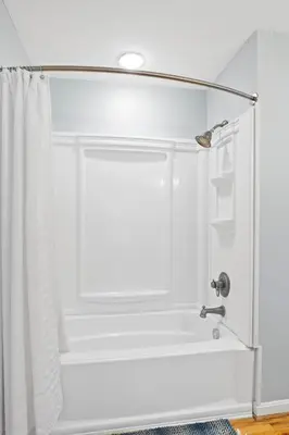 a bathroom with a shower curtain and a sink at Lakefront, Private Covered Dock, Huge Balconies in Williamstown