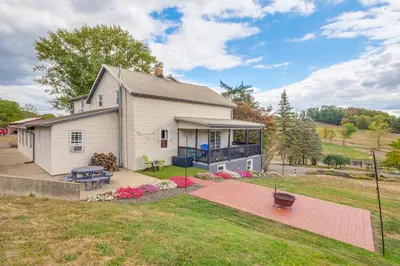 a white house with a patio and a yard at Meet Country Animals! Farmyard Stays Dundee Home in Dundee