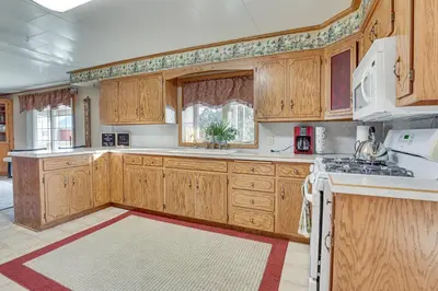 a large kitchen with wooden cabinets and white appliances at Meet Country Animals! Farmyard Stays Dundee Home in Dundee