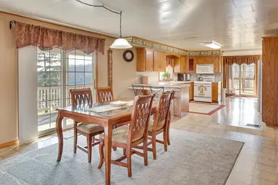 a dining room with a table and chairs and a kitchen at Meet Country Animals! Farmyard Stays Dundee Home in Dundee