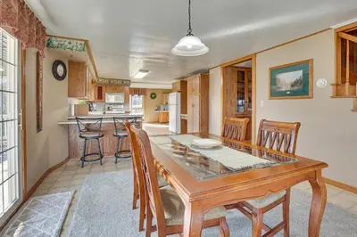 a dining room and kitchen with a table and chairs at Meet Country Animals! Farmyard Stays Dundee Home in Dundee