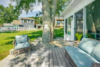 a porch with a couch and a tree at Montpelier Lake House with Deck, Dock and Fireplace! in Montpelier
