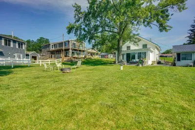 a yard with a house and a tree at Montpelier Lake House with Deck, Dock and Fireplace! in Montpelier