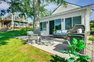 a patio with a tree and a grill at Montpelier Lake House with Deck, Dock and Fireplace! in Montpelier