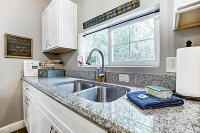 a kitchen with a sink and a window at Updated 3bd Cottage on Bike Trail w/ River access! in Loveland