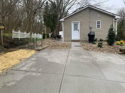 a house with a white door and a driveway at Updated 3bd Cottage on Bike Trail w/ River access! in Loveland