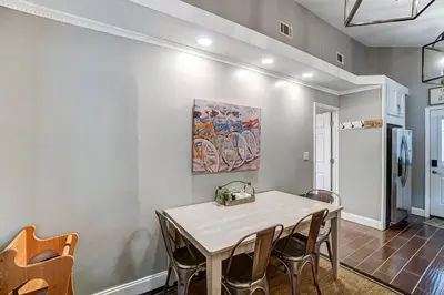 a dining room with a white table and chairs at Updated 3bd Cottage on Bike Trail w/ River access! in Loveland