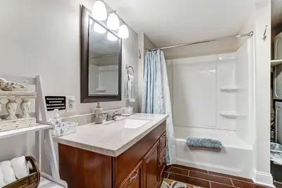 a bathroom with a sink and a shower at Updated 3bd Cottage on Bike Trail w/ River access! in Loveland